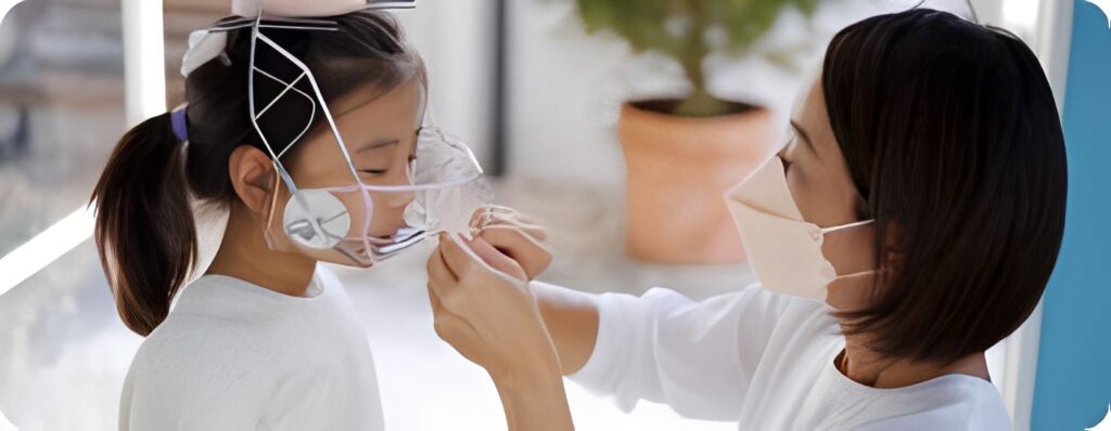 子どもに矯正器具を装着するお母さん